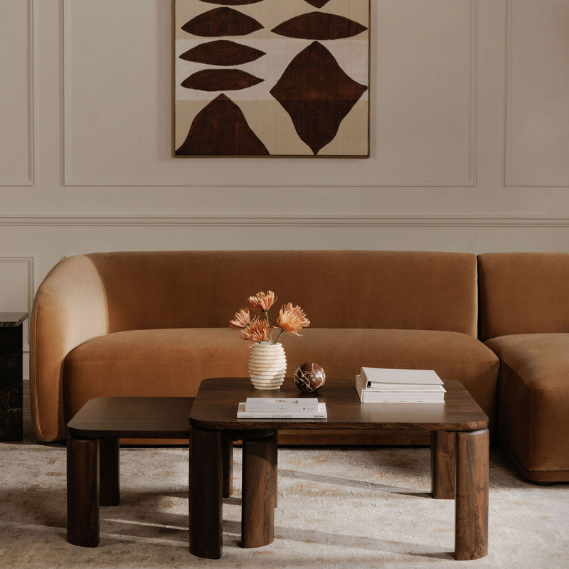 Framed abstract painting with beige background and dark brown geometric leaf shapes