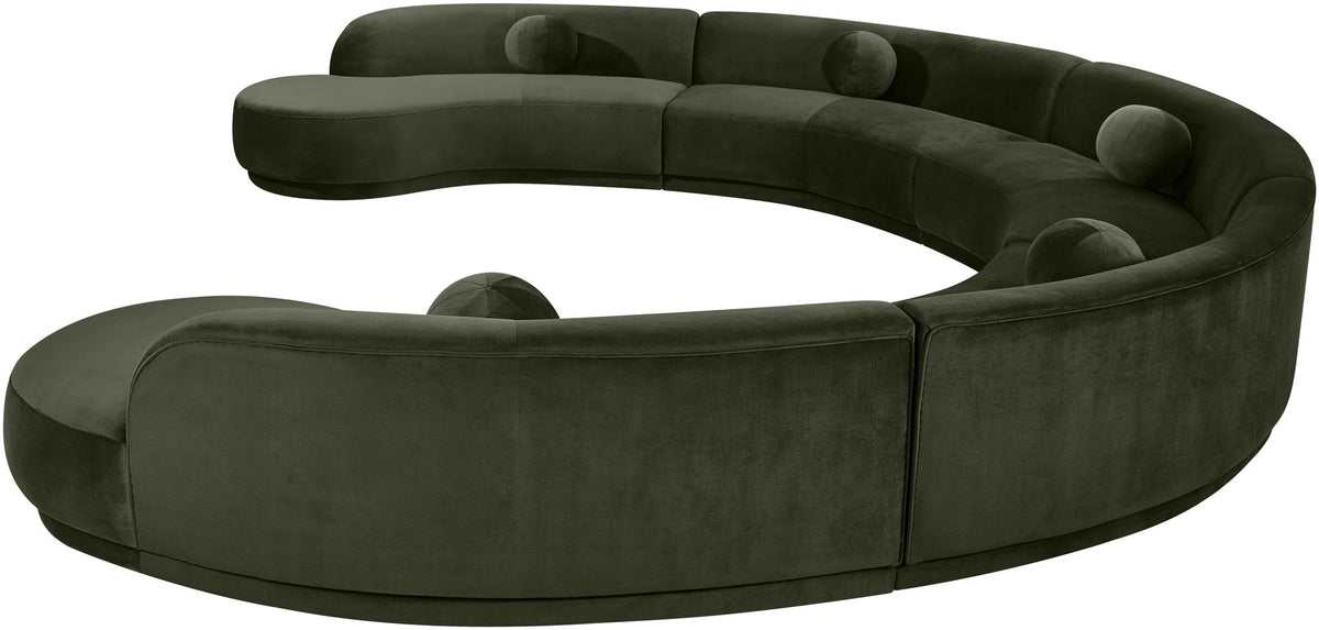 Dark green velvet sectional sofa, close-up of rounded seat and tufted cushions.