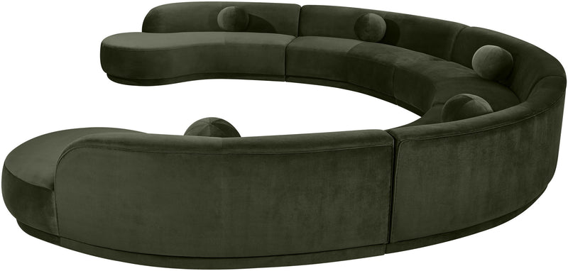 Dark green velvet sectional sofa, close-up of rounded seat and tufted cushions.