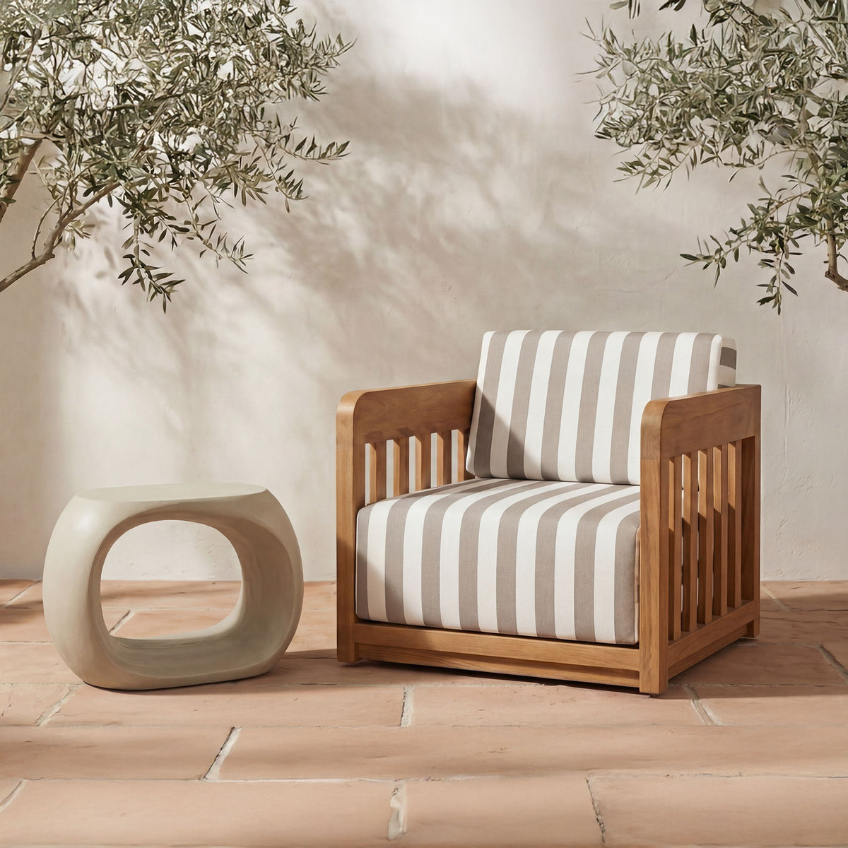 Cream outdoor stool, sculptural rounded design with oval opening