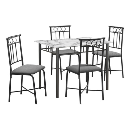 Small rectangular dining table set with black chairs and white marble-look tabletop