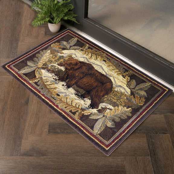 Lodge area rug with central bear medallion, leafy border, cream, brown, burgundy accents