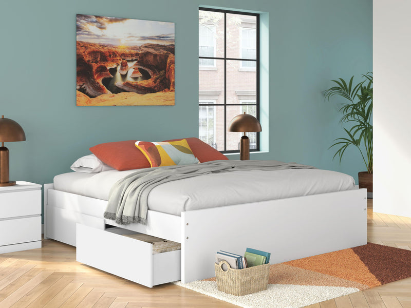White platform bed with one side storage drawer under white bedding