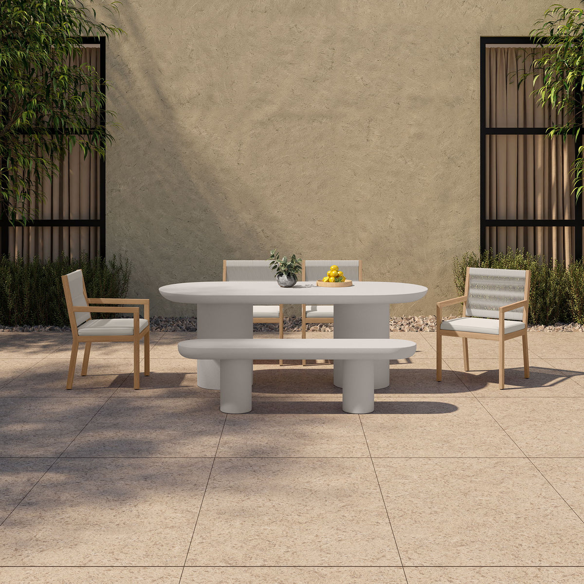 Cream oval dining table with pedestal legs in outdoor setting