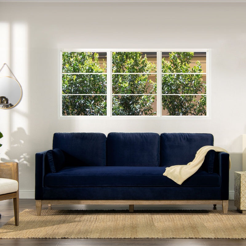 Modern farmhouse sofa in dark blue fabric with rolled arms and three back cushions