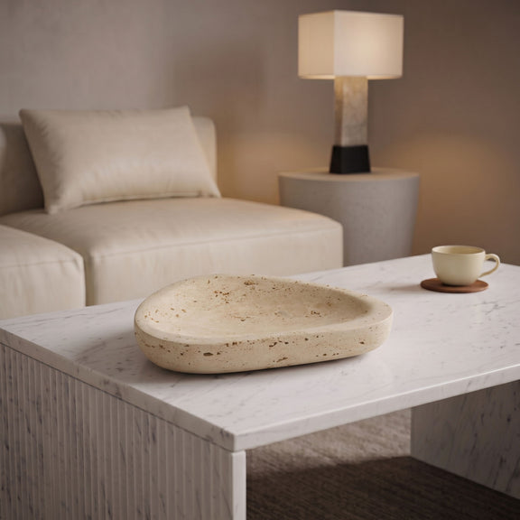 Beige travertine bowl on white console table in living room
