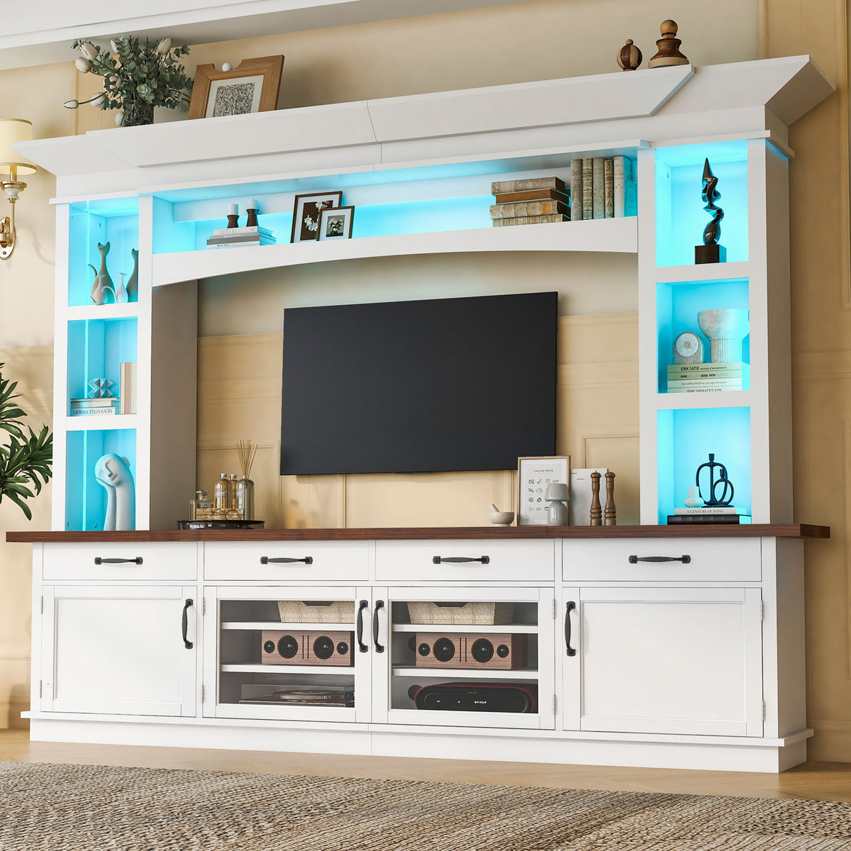 White TV stand with built-in blue LED shelves, open center area, and storage cabinets