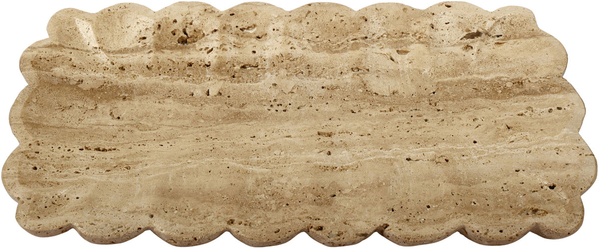 Beige travertine tray laid flat, scalloped edges and textured stone surface