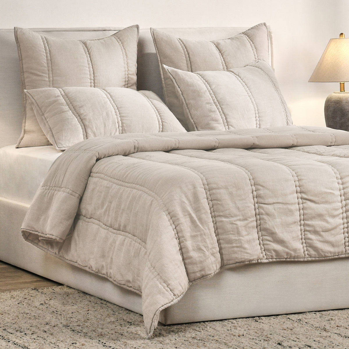 Set of light taupe square throw pillow shams with vertical stitched panels and piped edges