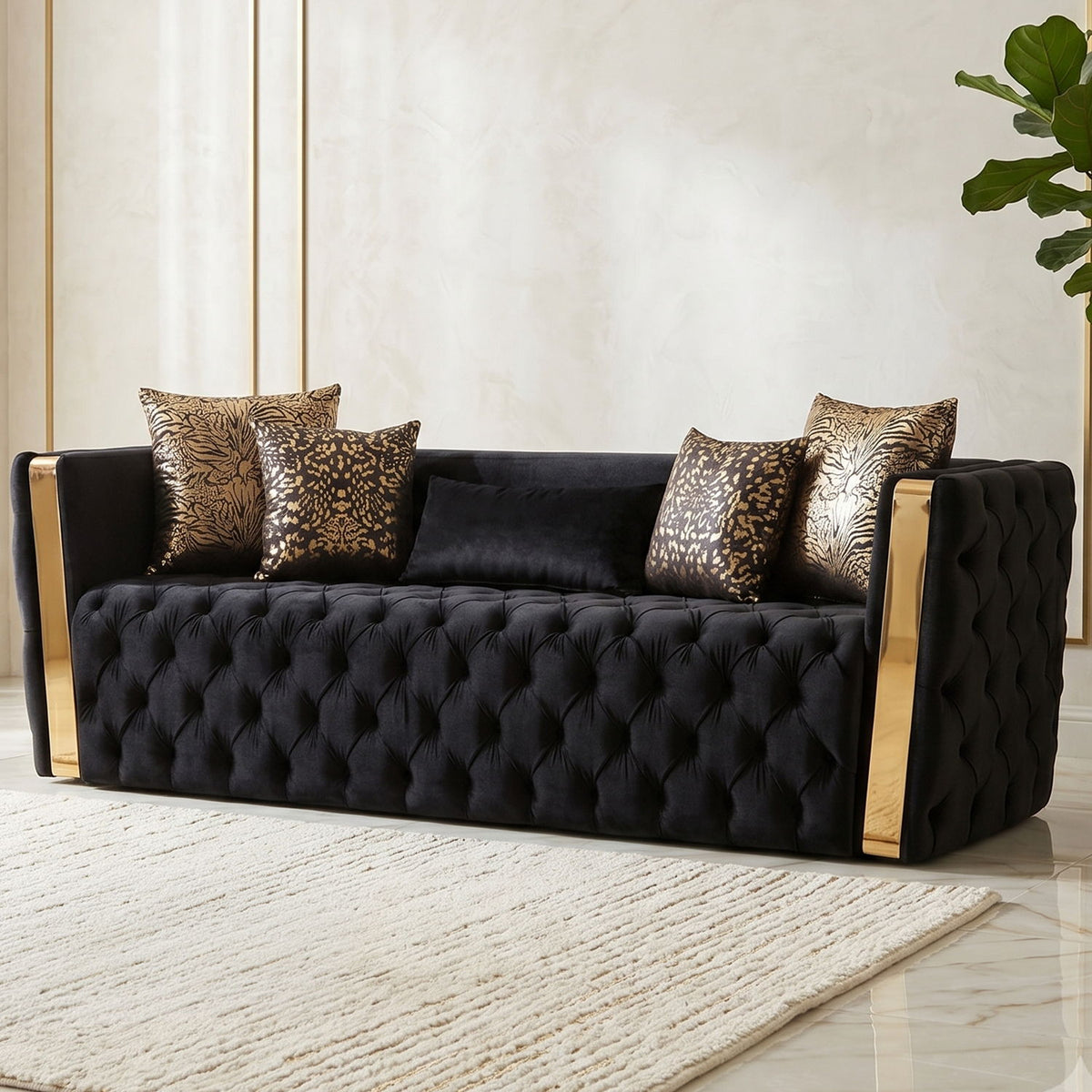 Front view of black tufted sofa with gold-finish arms and four patterned cushions