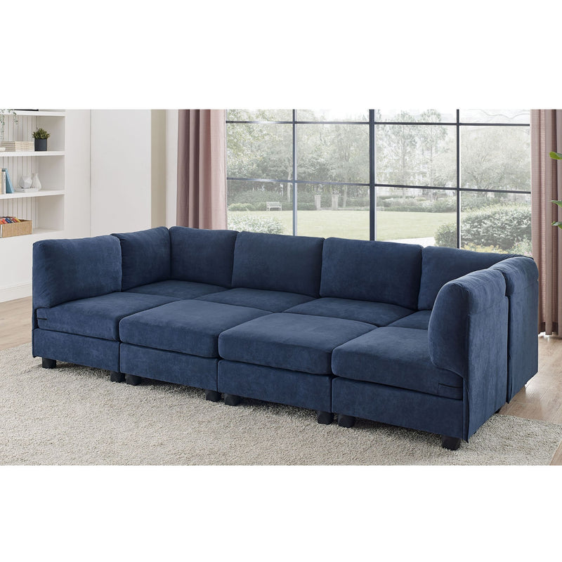 Blue modular sectional sofa with removable cushions, rounded arms, and ottoman bench seats