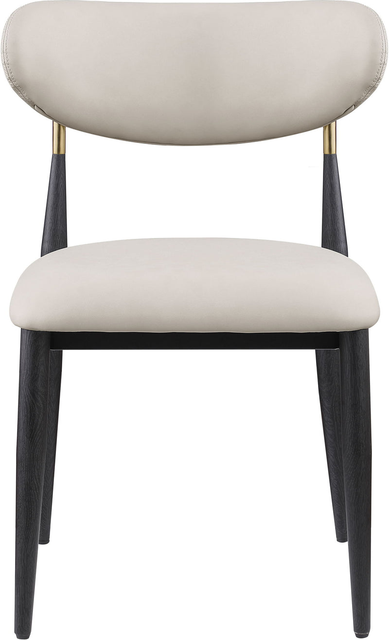 Cream vegan leather dining side chair with rounded back and seat, black legs with gold tips