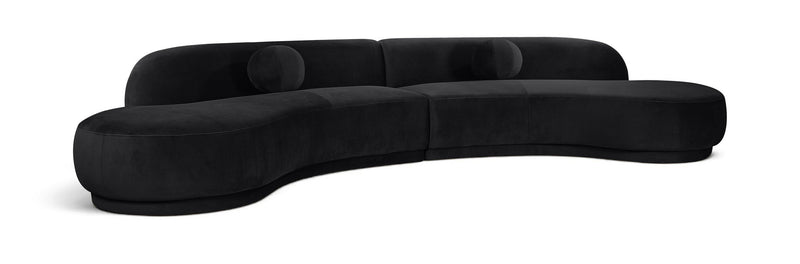 Black velvet sectional sofa with tufted cushions and curved chaise profile
