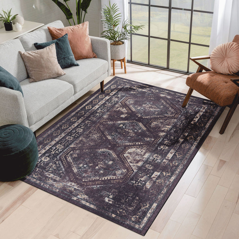 Dark gray washable area rug with distressed ornate medallion and geometric lines