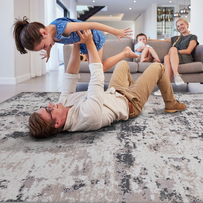 Abstract area rug, blue-gray distressed abstract pattern with beige and orange specks.