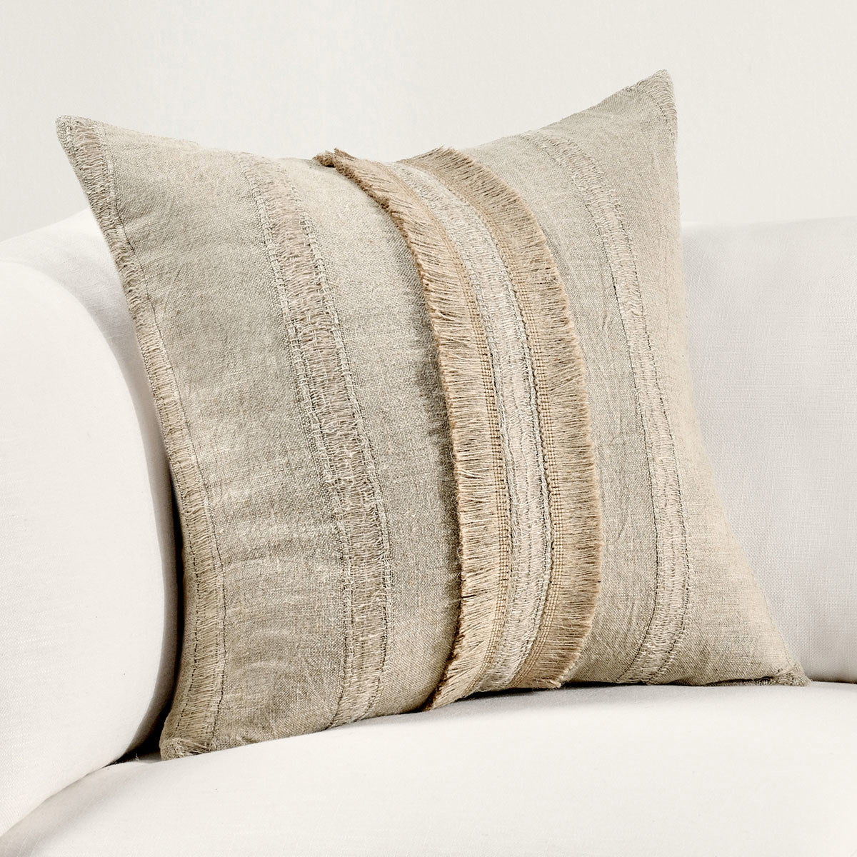 Natural linen pillow with vertical stitched stripes and fringed trim