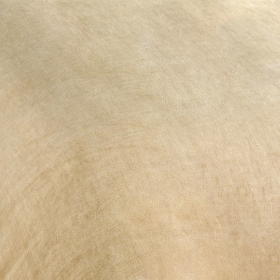 Ochre hemp fabric close-up with visible woven texture and natural flecks