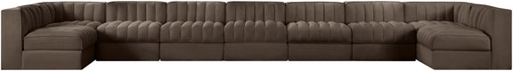 Brown velvet modular sectional sofa with tufted back and curved armrests