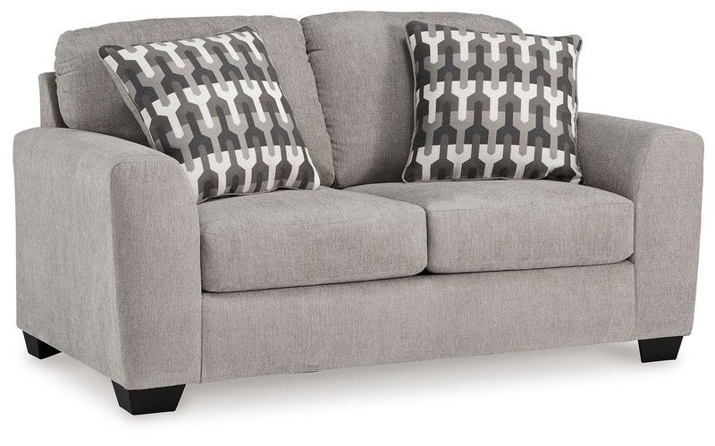 Gray flannel loveseat with two seat cushions and two patterned throw pillows