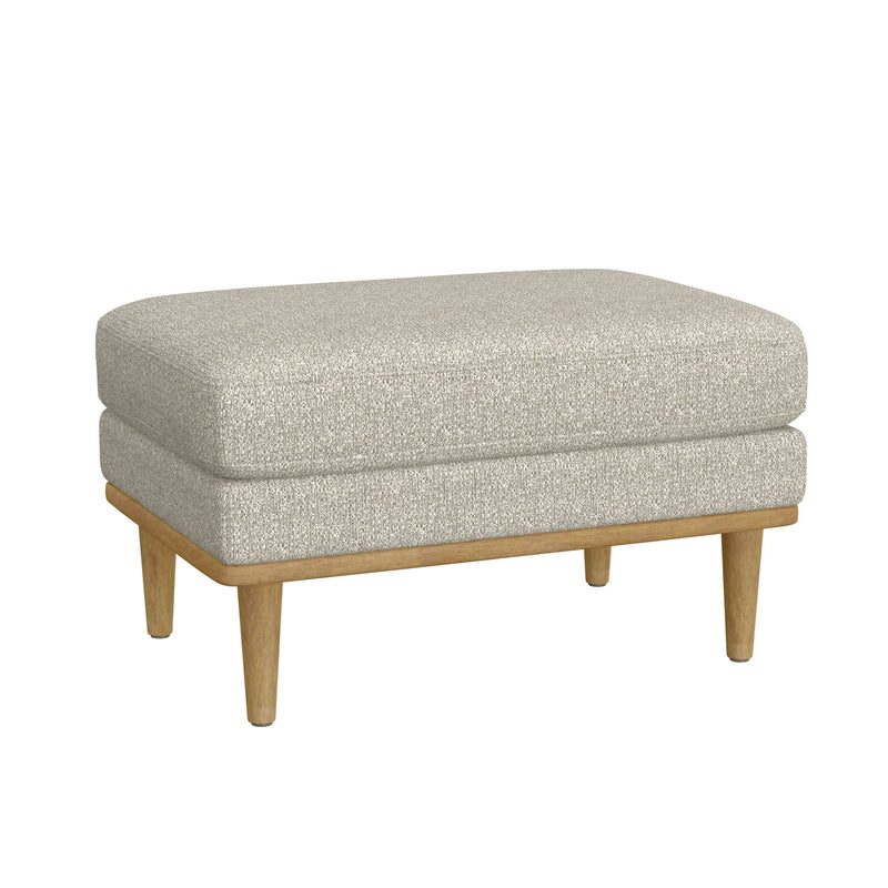 Tan upholstered ottoman with rounded top and wooden tapered legs.