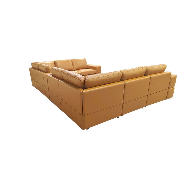 Light brown sectional sofa with large square arms, corner unit and chaise-style seat
