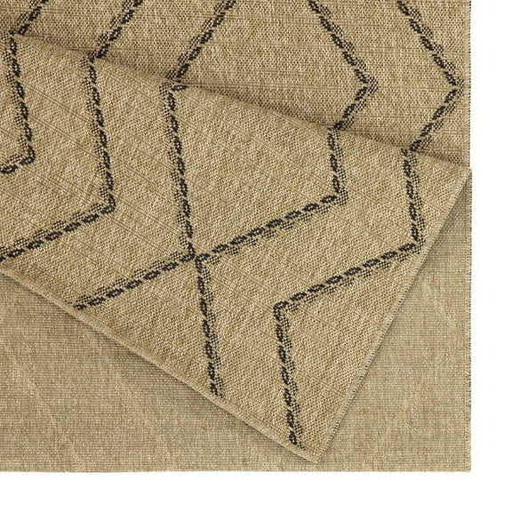 Light brown area rug corner with stitched geometric lines on textured weave
