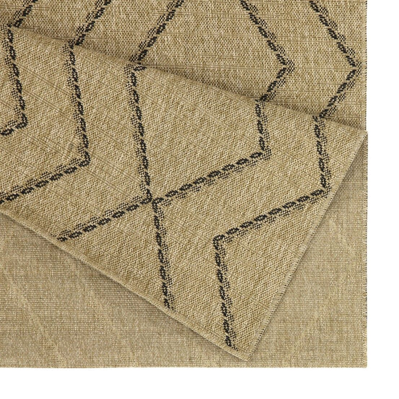 Light brown area rug corner with stitched geometric lines on textured weave