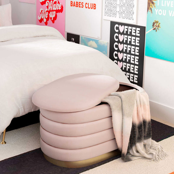 Pink velvet storage bench with padded lid and gold base