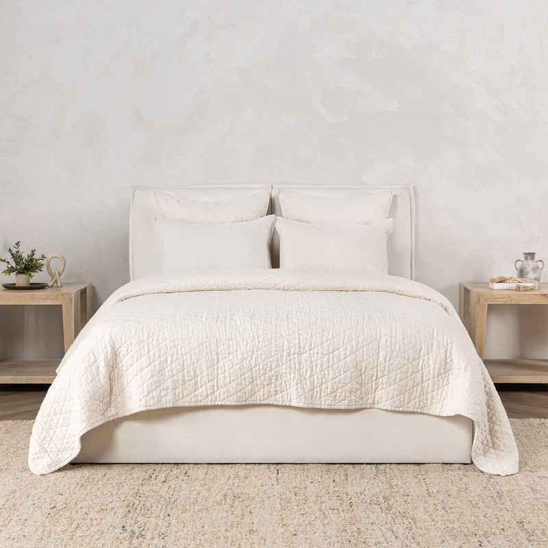Ivory quilt set with two pillows and quilt cover in bed