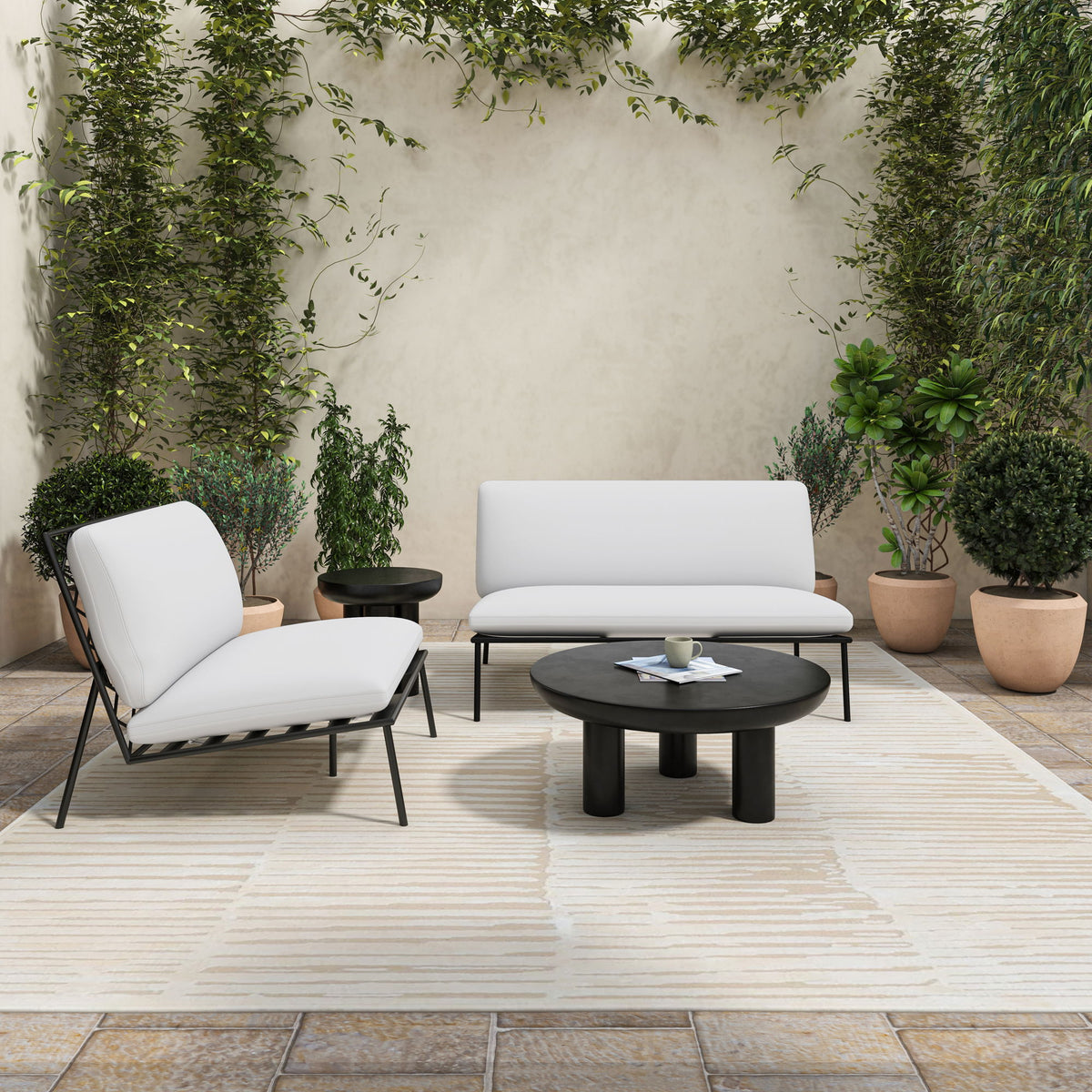 Round black cement coffee table with thick tabletop and three legs