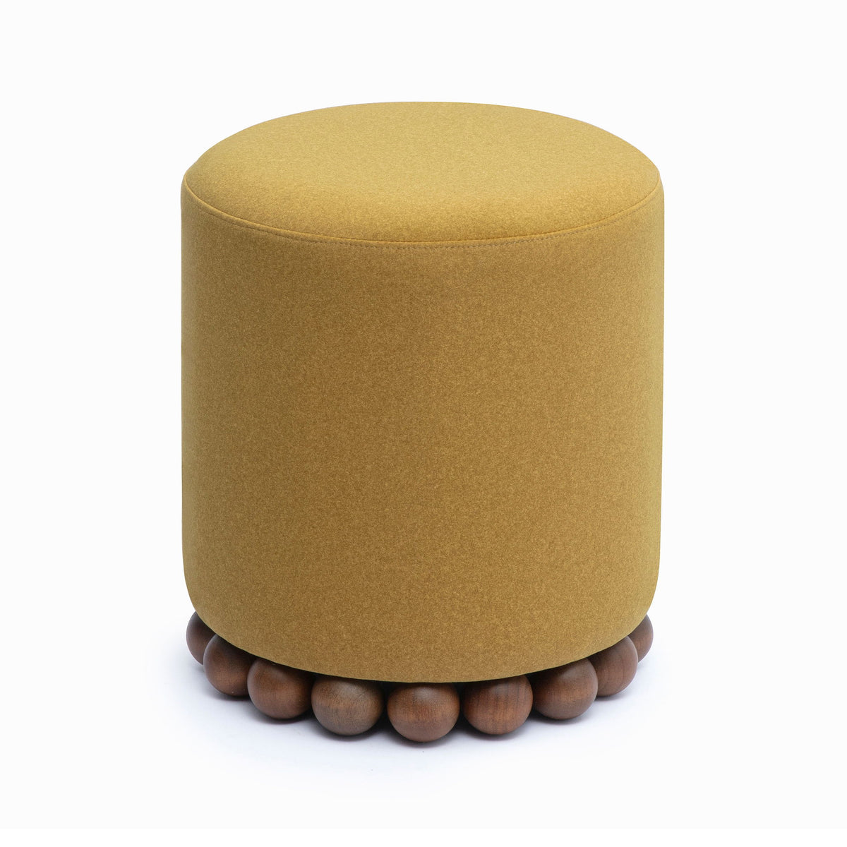 Round upholstered ottoman in light brown with beaded wooden base, side view