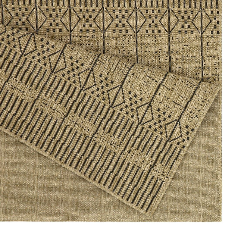 Area rug corner close-up: beige flatweave with dark diamond and stripe pattern