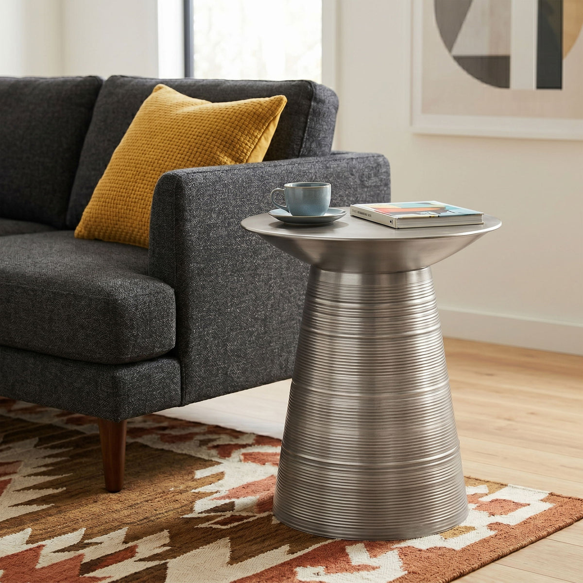 Silver round metal accent table with fluted pedestal base and circular tabletop
