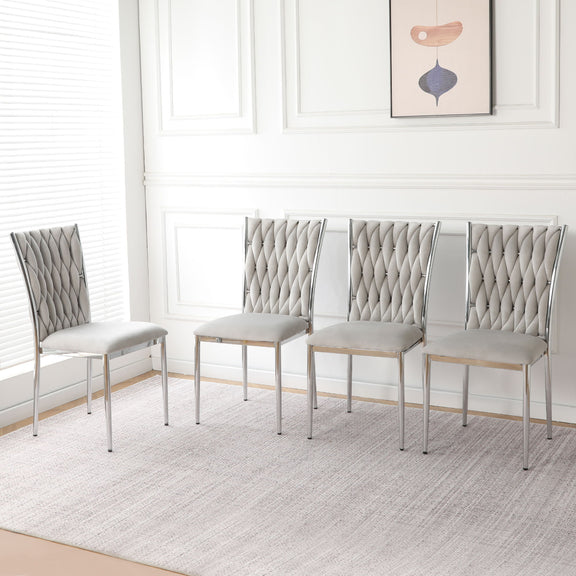 Set of four light gray tufted dining chairs with chrome legs and padded seats
