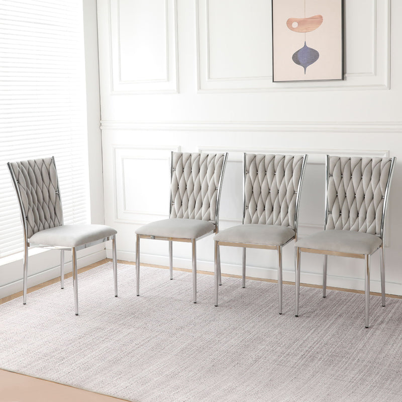 Set of four light gray tufted dining chairs with chrome legs and padded seats