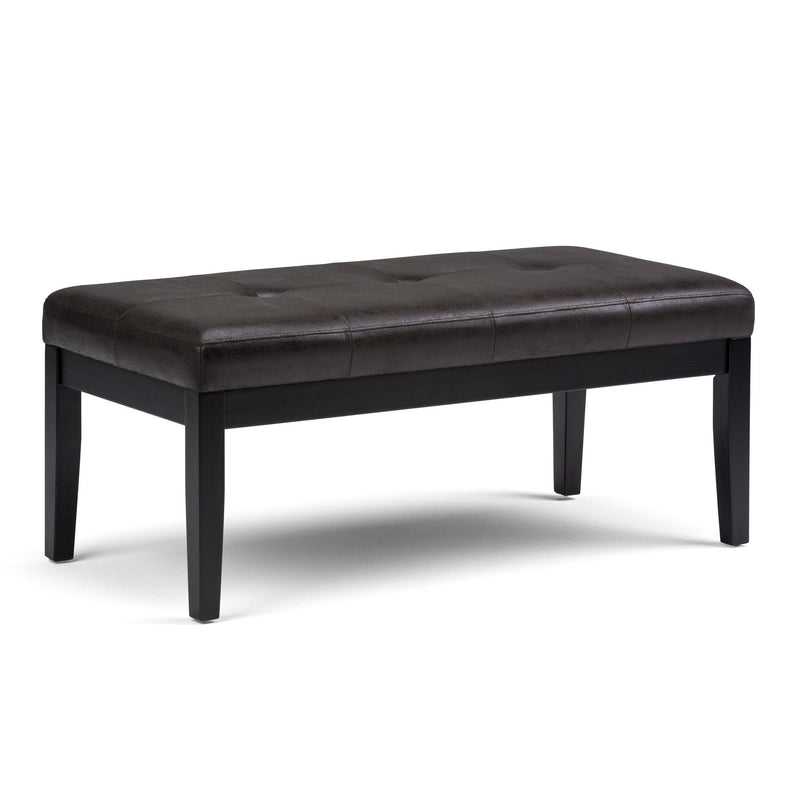 Black upholstered tufted ottoman bench with square padded top and tapered legs