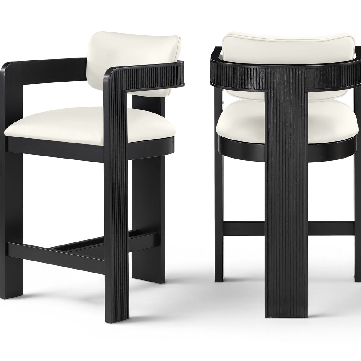 Two white vegan leather counter stools with fluted backs and black frames