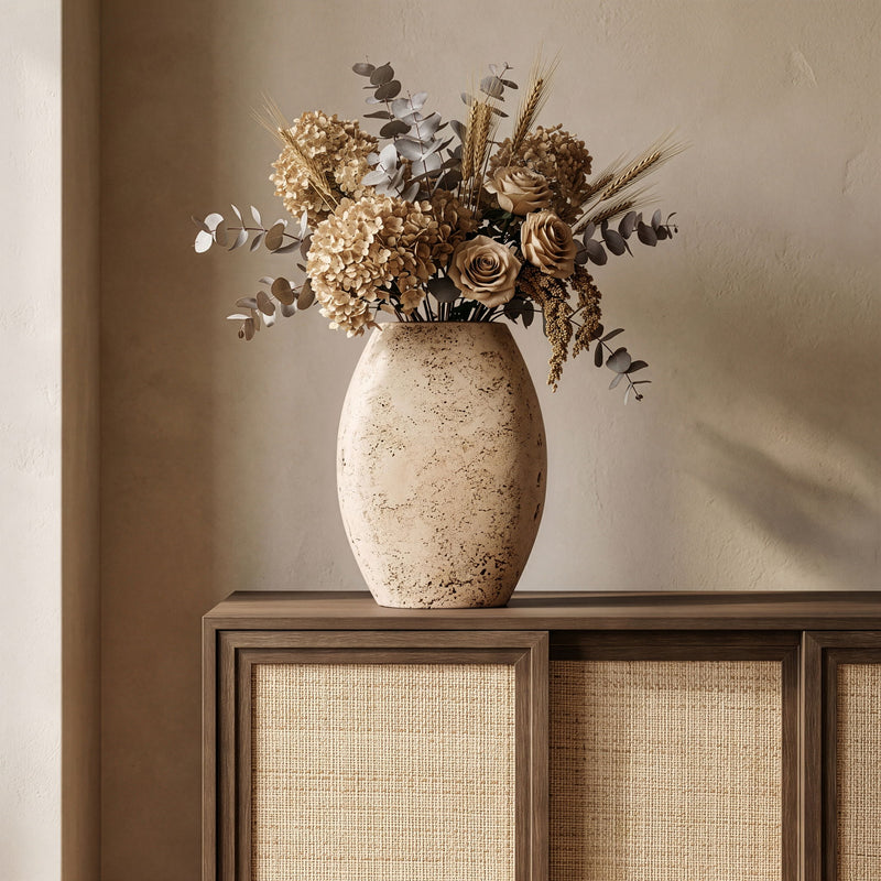 Beige textured vase holding a mixed floral arrangement