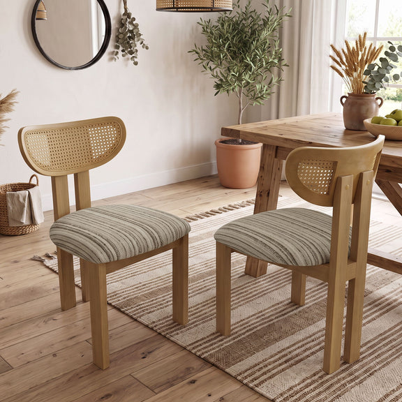 Pair of dining chairs with striped gray seats, light wood frames, and woven rattan backs