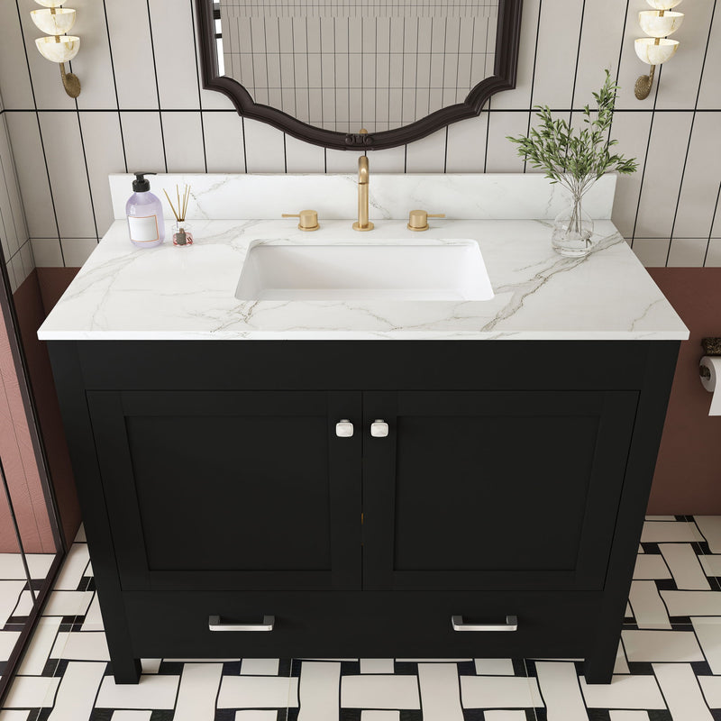 Black bathroom vanity with white marble-look top, two doors, and built-in sink basin