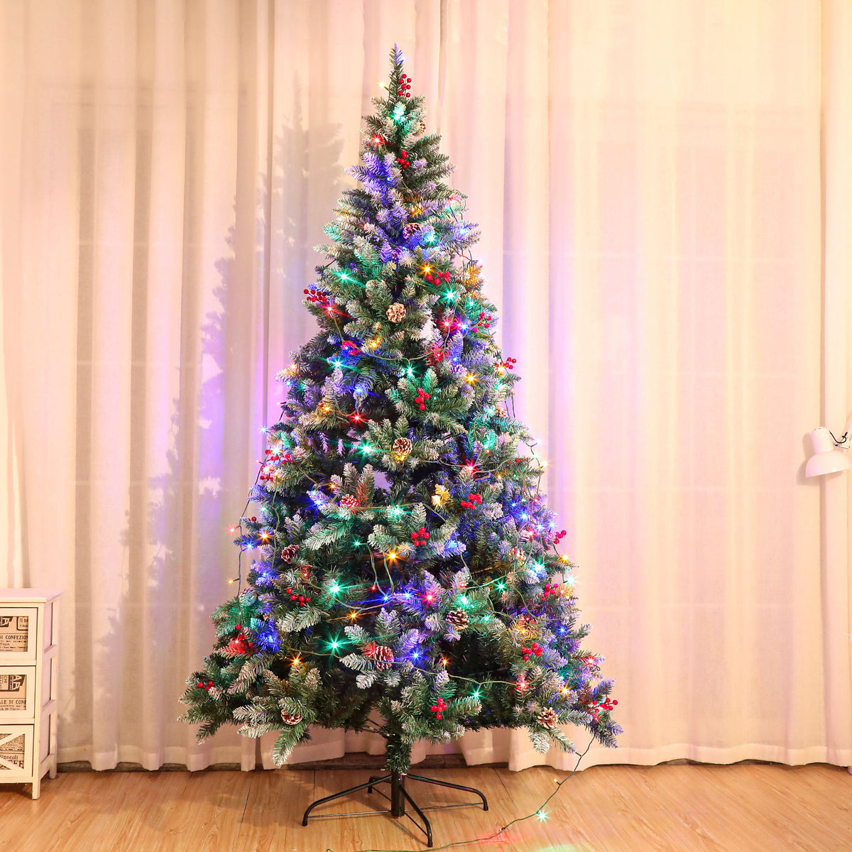 Artificial Christmas tree with multicolor LED lights, red ornaments, and snowy dark-green tips