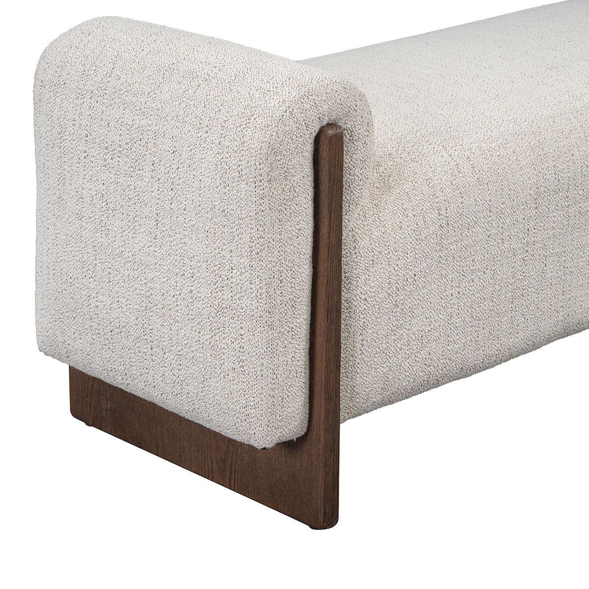 Upholstered bench side view with rounded arms, light sand fabric and dark wood legs