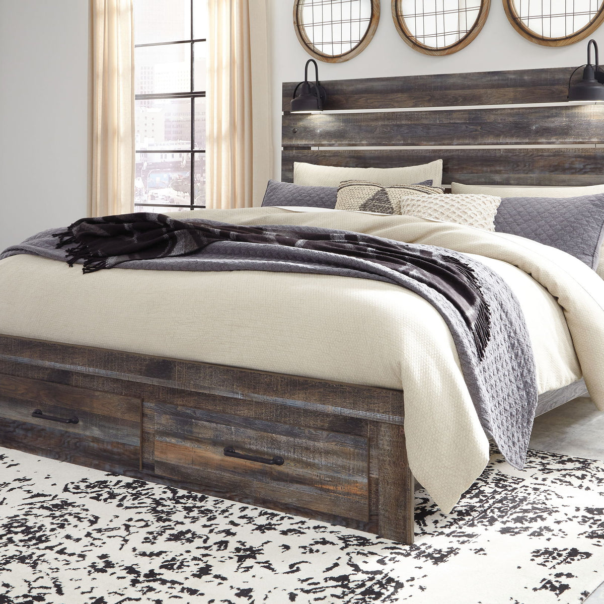 Drystan panel bed with dark wood frame and slatted headboard, dressed in neutral bedding