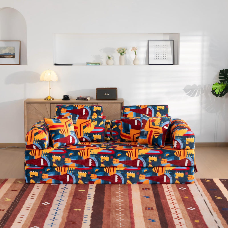 Convertible sofa bed in colorful city-pattern fabric with matching throw pillows