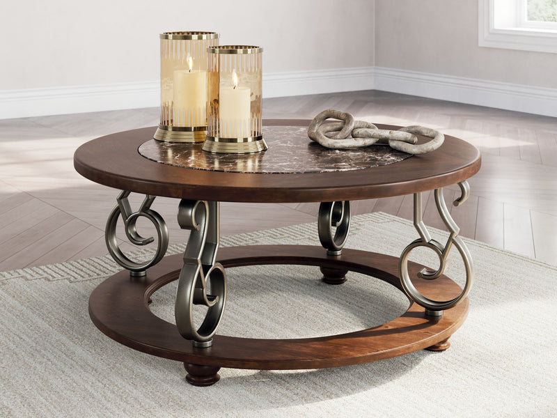 Dark brown round cocktail table with stone-look top, lower shelf, scrolling metal frame