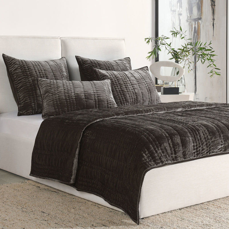 Dark brown quilted square sham pillows with vertical stitching and piped edges