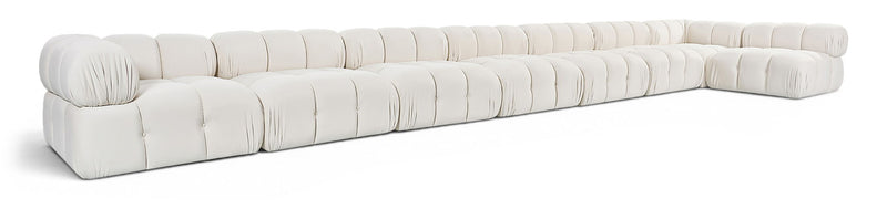 L-shaped velvet sectional sofa in white with tufted cushions and rolled arm corners