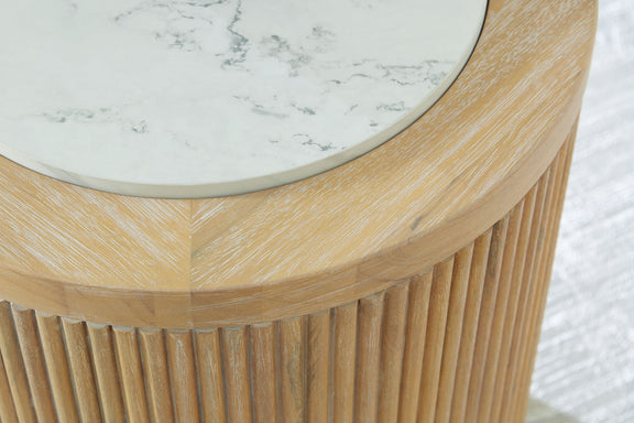 Close-up of round table edge with light wood slats and white marble surface