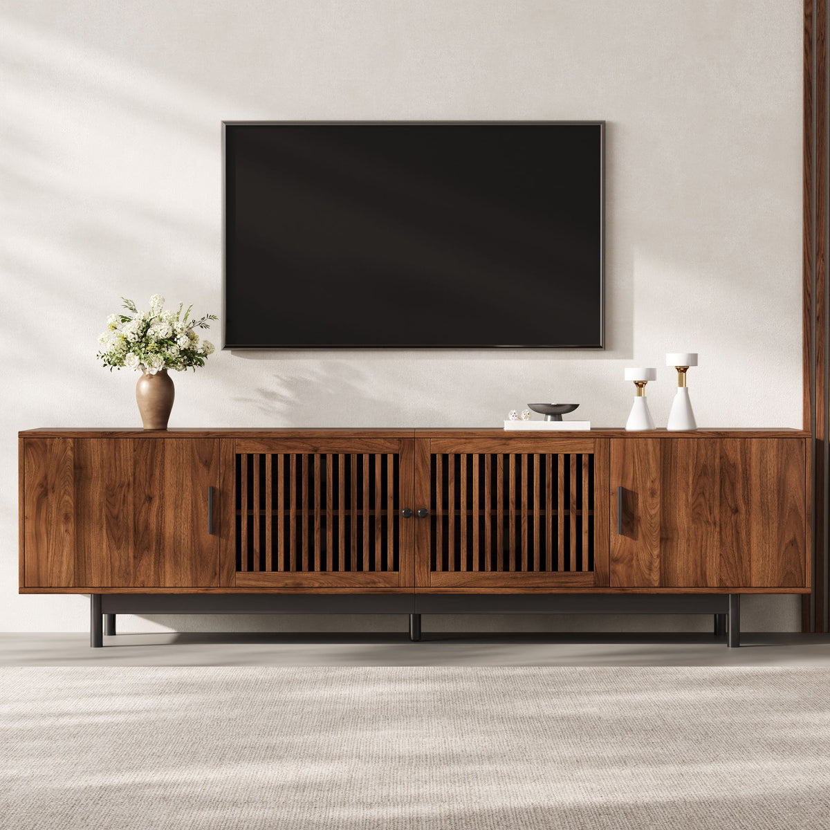 Walnut media console with slatted door panels and an open center TV shelf