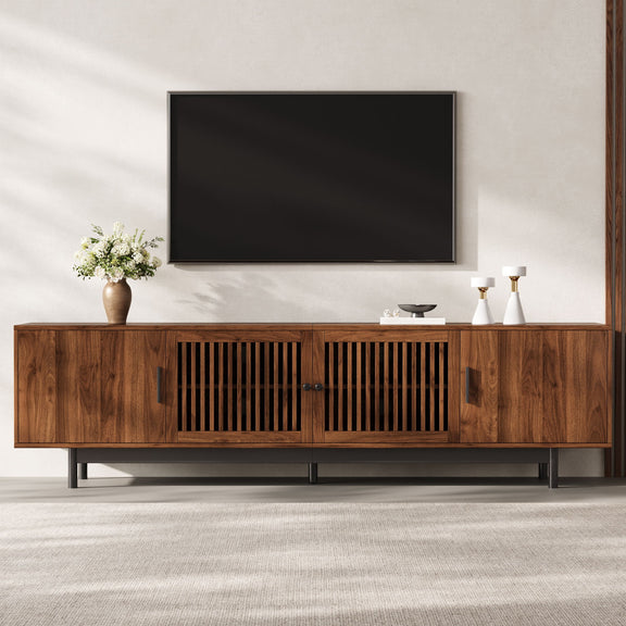 Walnut media console with slatted door panels and an open center TV shelf